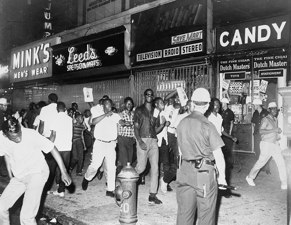 Rioters race through Harlem streets carrying pictures of Lt. Thomas Gilligan in 1964. Gilligan fatally shot ninth-grader James Powell.